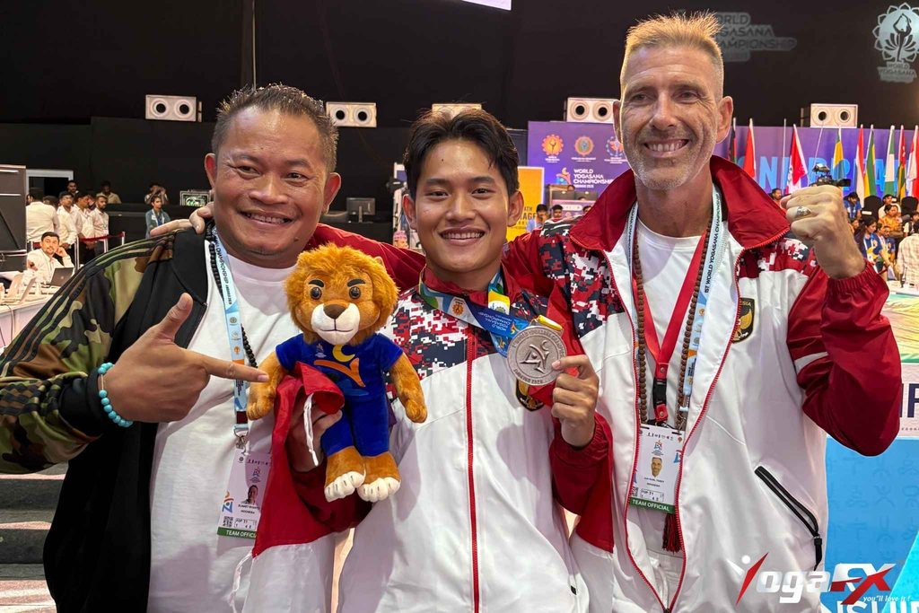 Arkan Fauzan Riyanto, YogaFX graduate, with the two silver and three bronze medals he won at the World Yogasana Championship