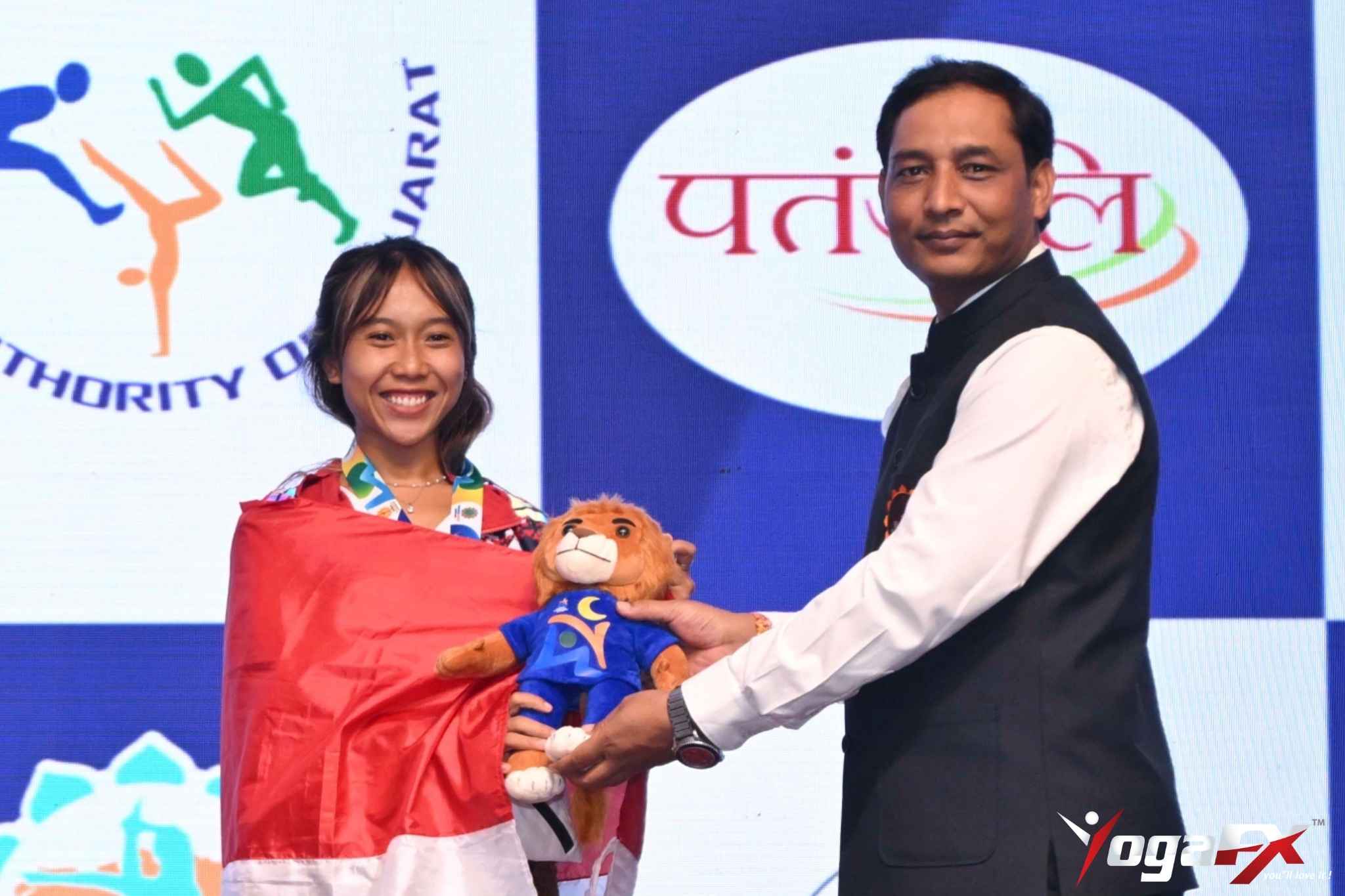 Ivara Candra Kartika, 2023 YogaFX RYT 200 graduate, holding gold and bronze medals from the World Yogasana Championship 2026 in Ahmedabad, India