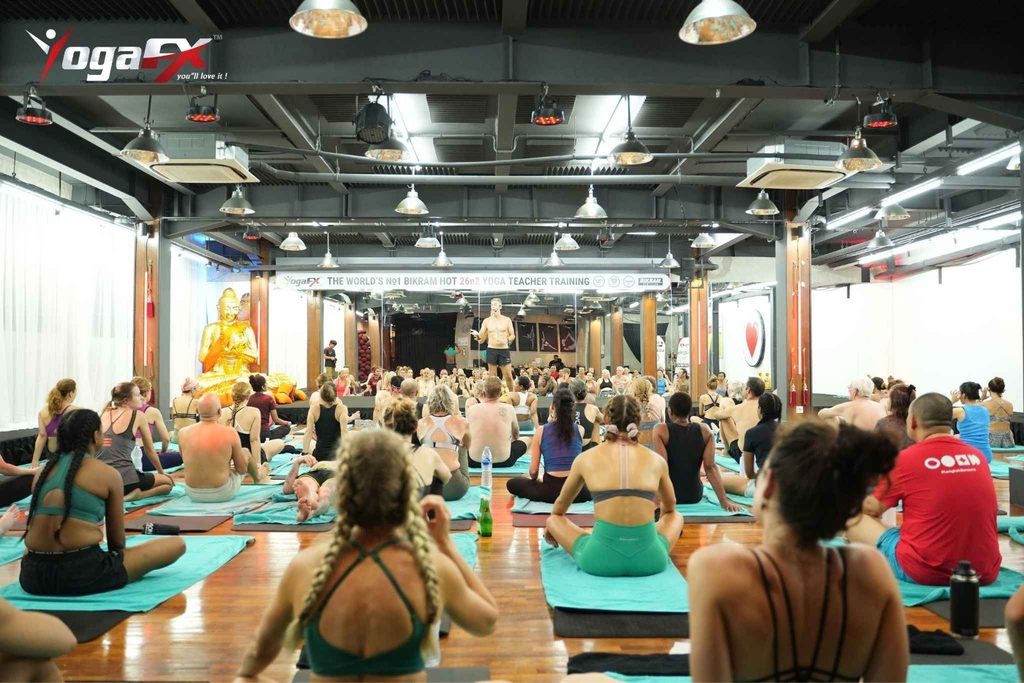 Mr. Ian Terry, E-RYT 500, correcting a trainee during posture clinic at YogaFX yoga teacher training in Seminyak, Bali