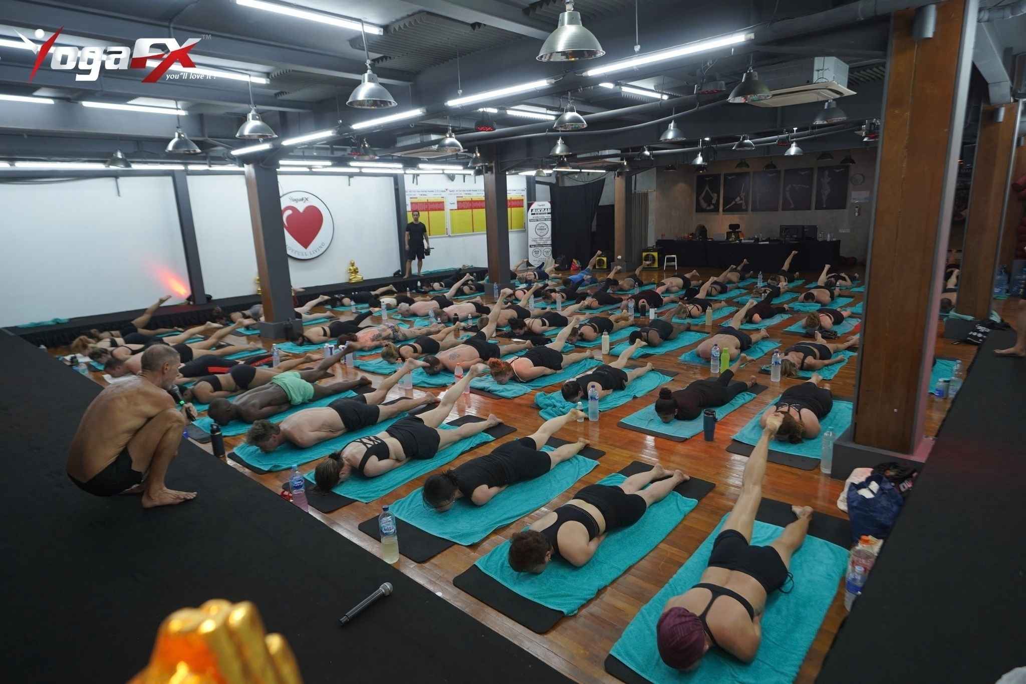 Students resting in Savasana during the floor series