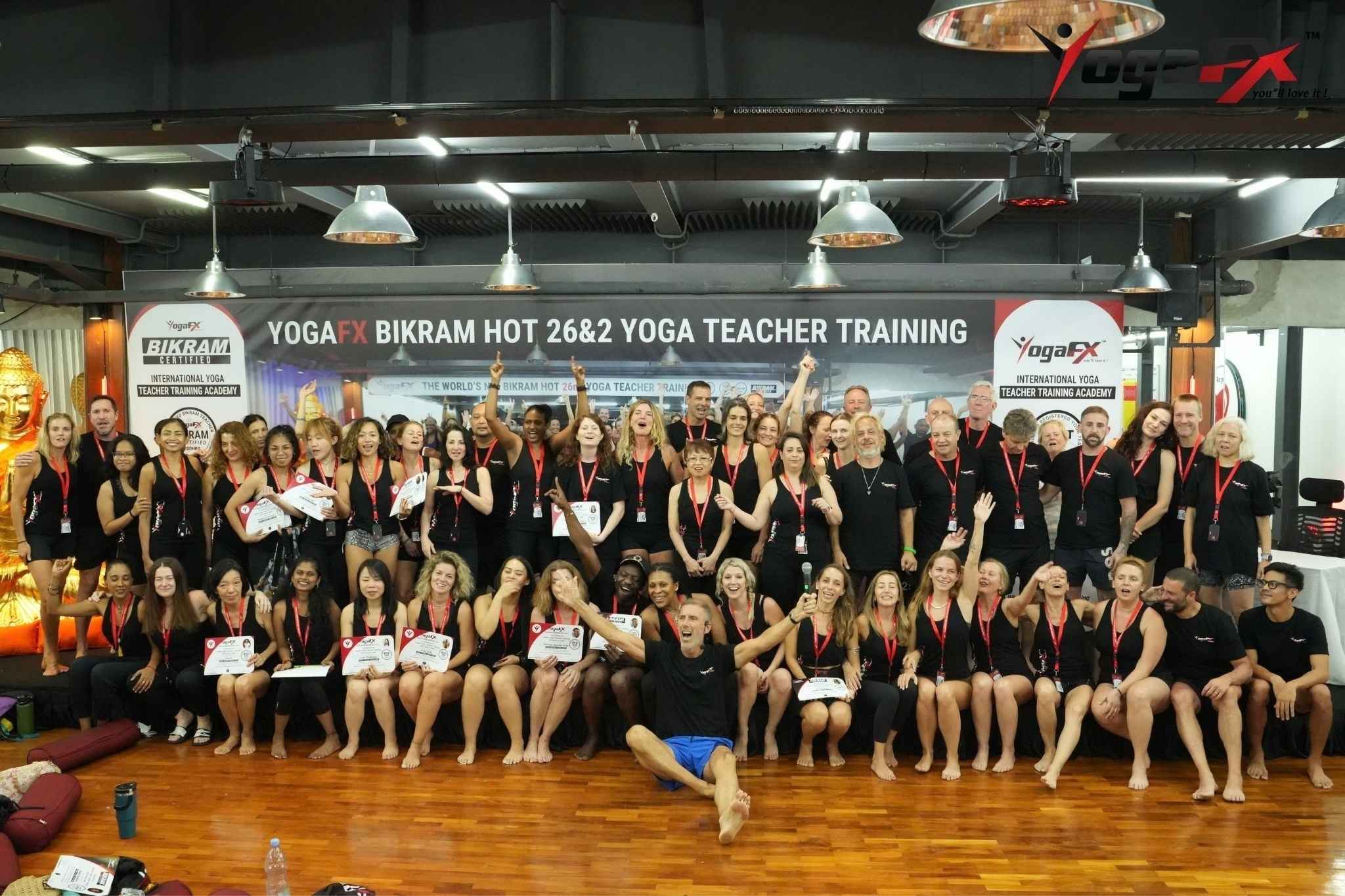 YogaFX teacher training graduates holding their certificates
